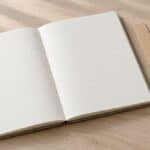 Blank grid notebook with a ruler, pencil and small hourglass on a tidy desk